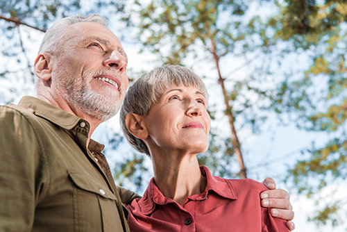 Elderly couple smiling and enjoying being outside